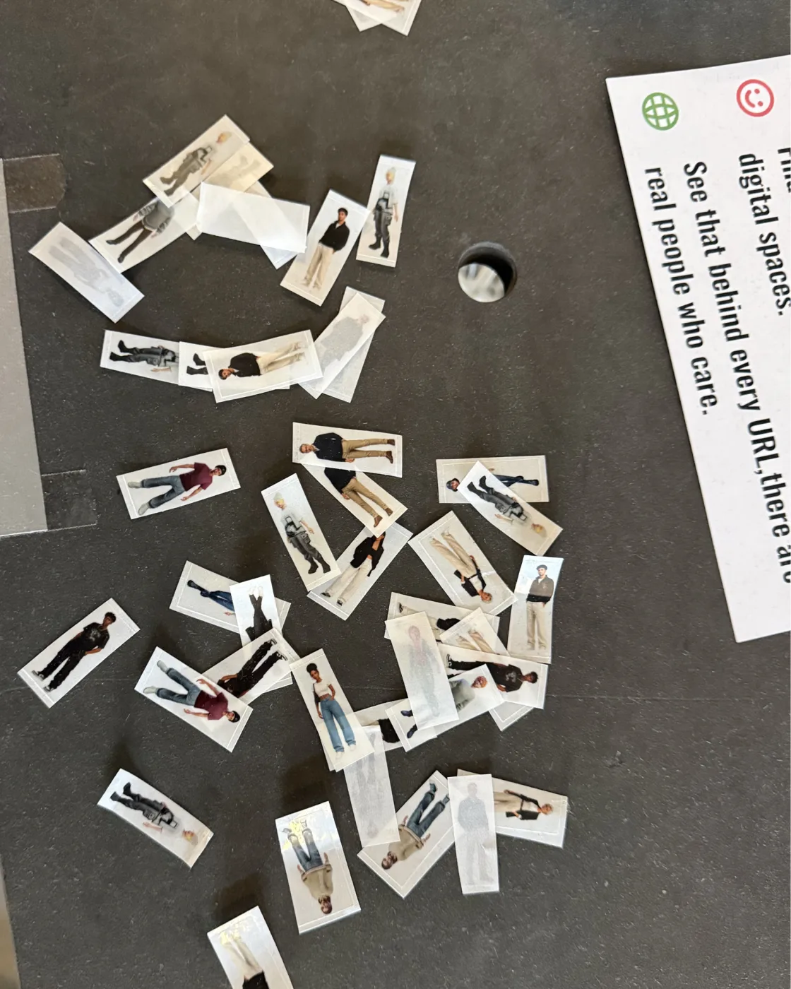 Printed avatar stickers — small cut-out figures of people — spread out on a table, ready to be placed